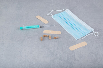 Medical protective mask with empty syringe and pills
