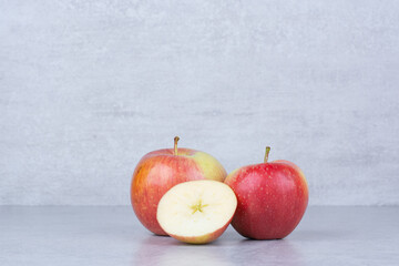 Two whole apple with slices on white background