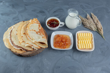 Breakfast arrangement decorated with wheat stalks on marble background