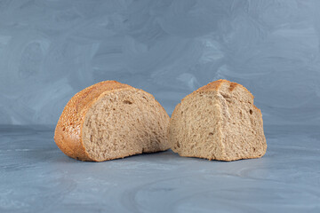 Modest slices of sesame covered bread on marble background
