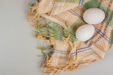 Fresh chicken white eggs on tablecloth