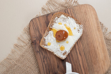 A wooden cutting board with toast on sackcloth