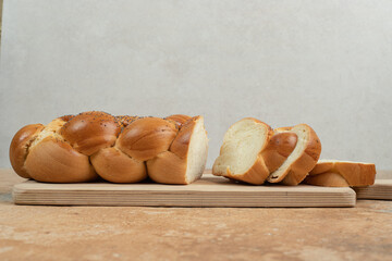 Sliced fresh white bread on wooden cutting board