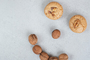 Round sweet cookies with walnuts on white background
