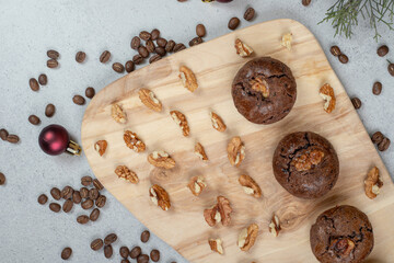 Chocolate cookies with walnuts and coffee beans on wooden board