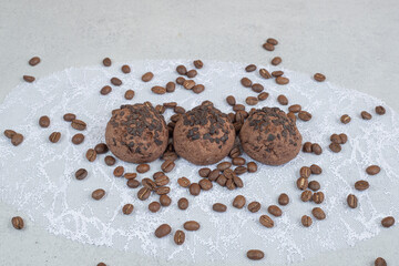 Chocolate cookies with coffee beans on white background