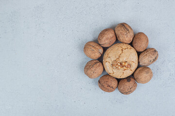 Round sweet cookies with walnuts on white background