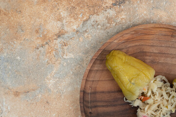 Pickled pepper stuffed with sauerkraut on wooden plate