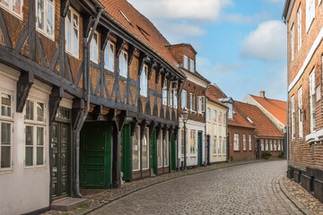 Fototapeta na wymiar Street and traditional houses in old town of Ribe, Jutland, Denmark