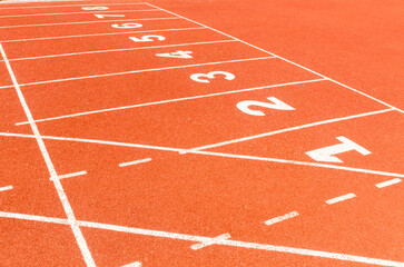 Start or finish position on running line track rubber lanes in the sport stadium.