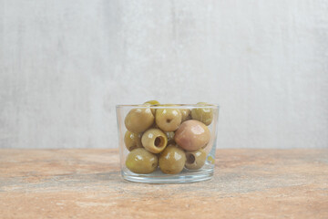 Pickled green olives in glass bowl