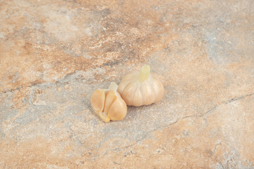 Homemade fermented garlic on marble background