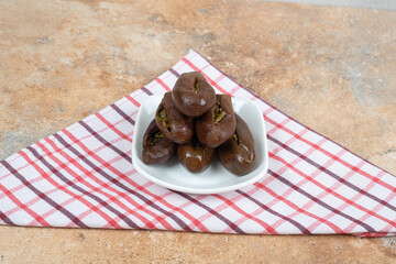 Homemade pickled eggplants on white plate