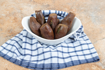 Stuffed pickled eggplants in white bowl