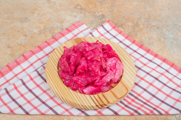 Pickled red cabbage on wooden plate