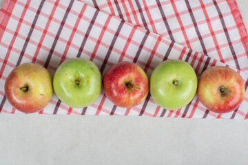 Colorful fresh apples on striped tablecloth