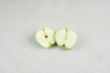 Half cut fresh apples on gray background