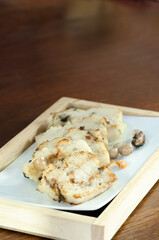 The delicious fried  turnip cake with black soy sauce. Dim Sum of turnip cake Chinese cuisine. Chinese traditional local dish radish cake. Chinese new year food.