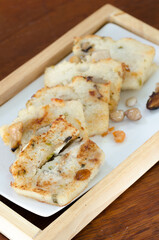 The delicious fried  turnip cake with black soy sauce. Dim Sum of turnip cake Chinese cuisine. Chinese traditional local dish radish cake. Chinese new year food.