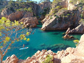 View of the sea from the cliff. Paddle surfing in S'Agar&oacute;, Mediterranean Sea, Costa Brava, Spain, Europe