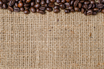 The coffee beans on the hessian sack; for background; texture; copy text