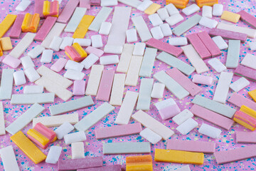 Assortment of chewing gums laid out on a colorful background