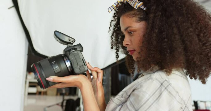 Photography camera and photographer black woman backstage for professional photoshoot. Entrepreneur or creative person taking photos with flash in studio for creativity career, job or student academy