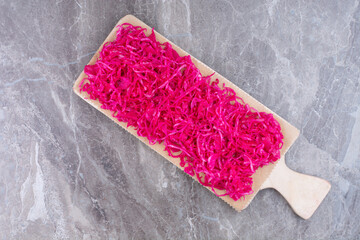 Fermented red cabbage on wooden board