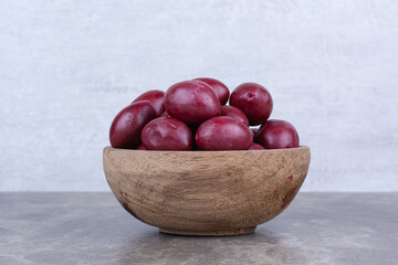 Homemade pickled fruits in wooden bowl