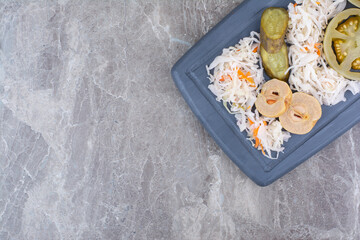 Assortment of homemade pickles on dark plate