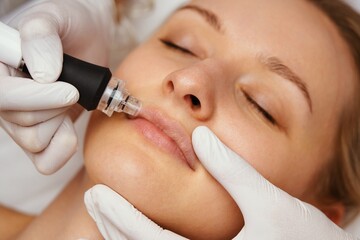 A cosmetologist performs hydropiling in a beauty salon. Skin care.