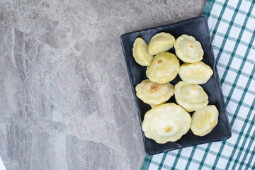 Homemade pickled vegetables on black plate
