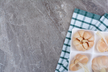 Tasty pickled garlic on white plate