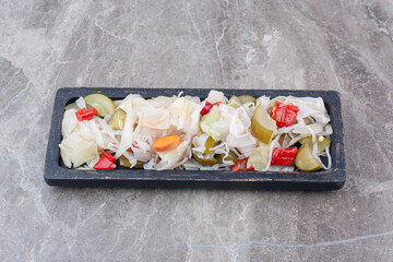 Variety of chopped pickles on dark plate