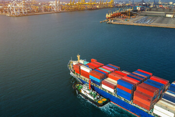 Aerial view of cargo ship and cargo container in harbor.