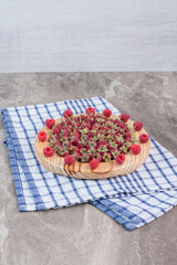 Raspberry snack platter on a towel, on marble background
