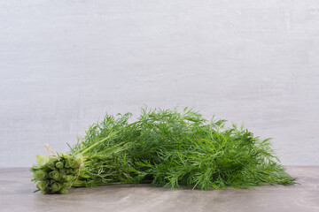 Small bundle of dill on marble background