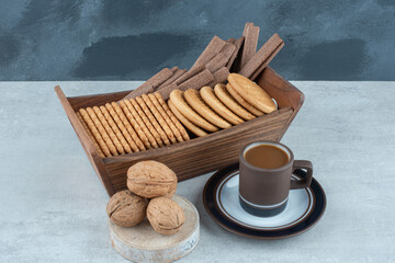 A cup of coffee with walnuts and cookies