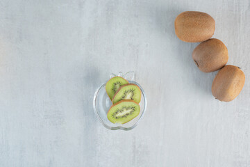 Tasty kiwi with slices on white background