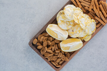 A lot of delicious food to the beer on wooden board