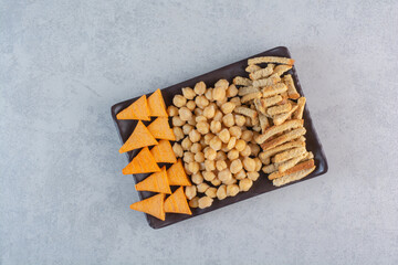 A lot of delicious food to the beer on black plates