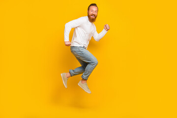Full length profile photo of beard man run wear shirt jeans shoes isolated on yellow color background