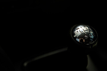 Gear shift lever of the car in the dark background
