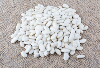 Small pile of navy beans on textile background