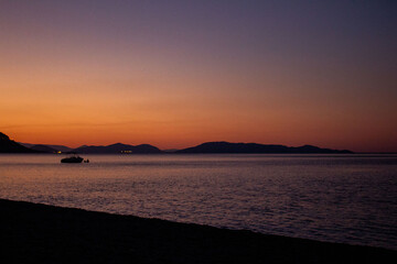 sunrise on the beach, mountain on the horizon