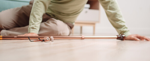 Asian senior man falling on the ground with walker in living room at home. Elderly older mature male having an accident heart attack for emergency help support from hospital. Insurance health care.