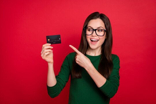 Photo of impressed brunette ceo lady index look card wear spectacles green shirt isolated on red color background