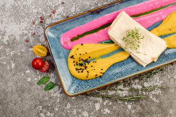 Dish of pumpkin puree and herbs