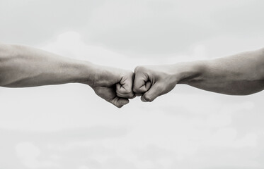 Teamwork and friendship. Partnership concept. Man giving fist bump. Bumping fists together. Black and white