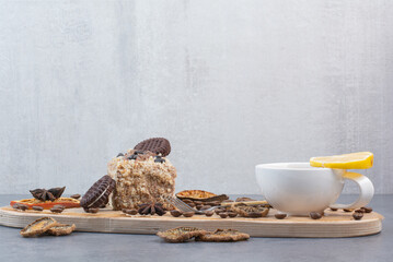 A wooden cutting board with dried oranges and coffee beans